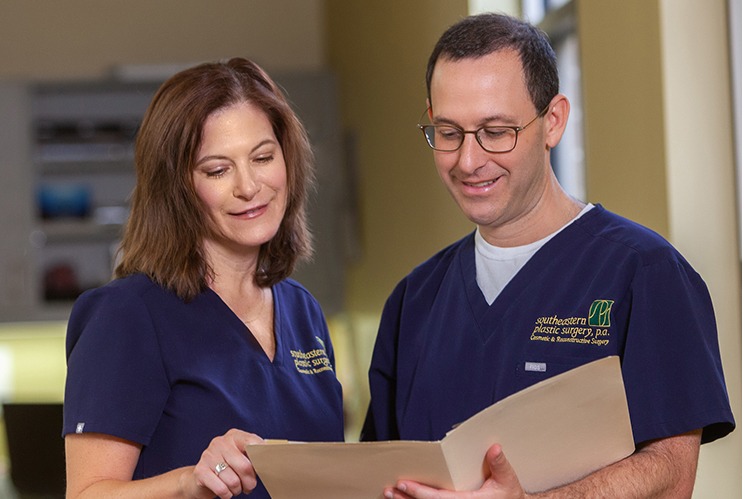 Dr. Rosenberg discussing patient's file with a team member