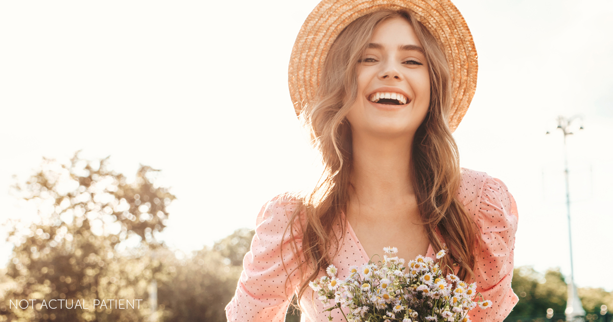 An advertisement image for spring specials at Southeastern Plastic Surgery, P.A.. The image features a woman holding a bouquet of pink and white flowers while standing in a field of green grass and trees.