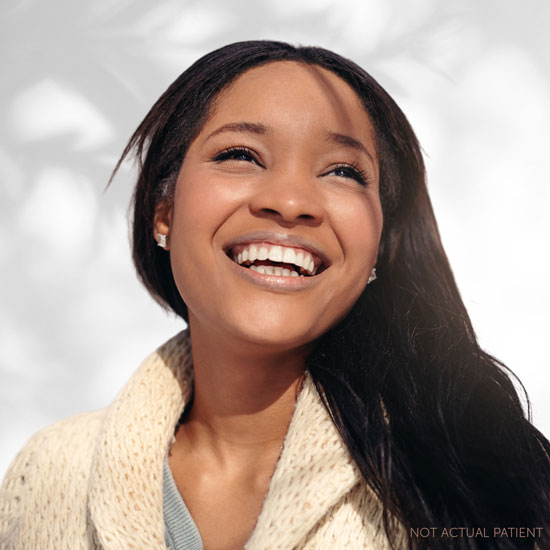 Black woman enjoying a pretty flower