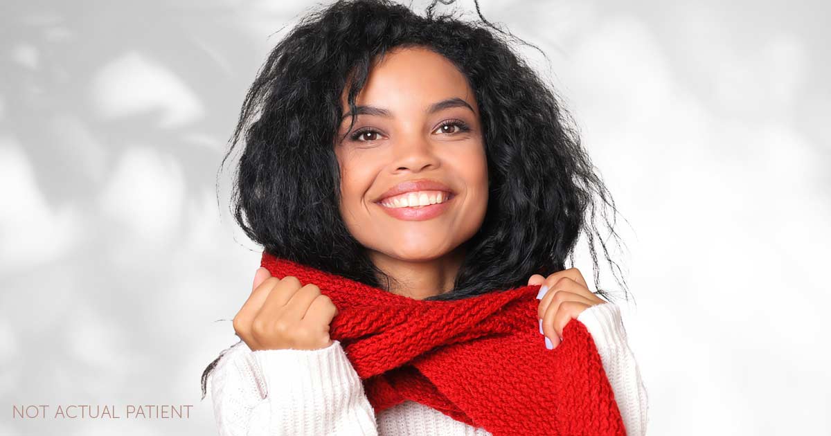An advertisement image for winter specials at Southeastern Plastic Surgery, P.A.. The image features a smiling woman putting on a red scarf smiling.