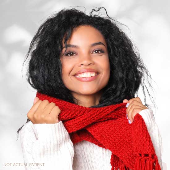 An advertisement image for winter specials at Southeastern Plastic Surgery, P.A.. The image features a smiling woman putting on a red scarf smiling.