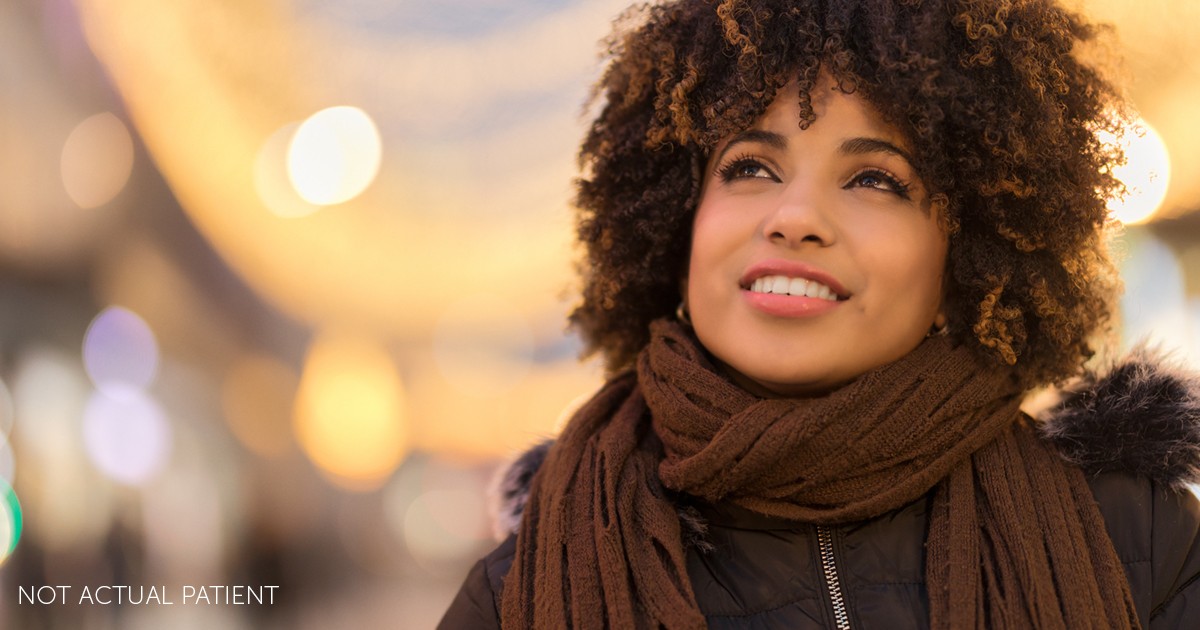 Beautiful Elegant woman standing in a park in Winter