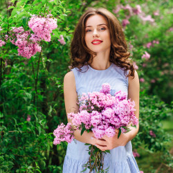 Young girl stand at park background with bouquet of flowers