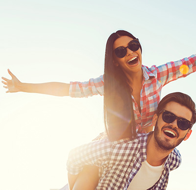 Smiling couple wearing sunglasses