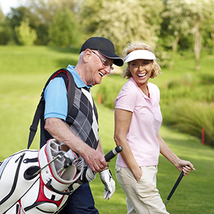 Smiling couple on a golf course 
