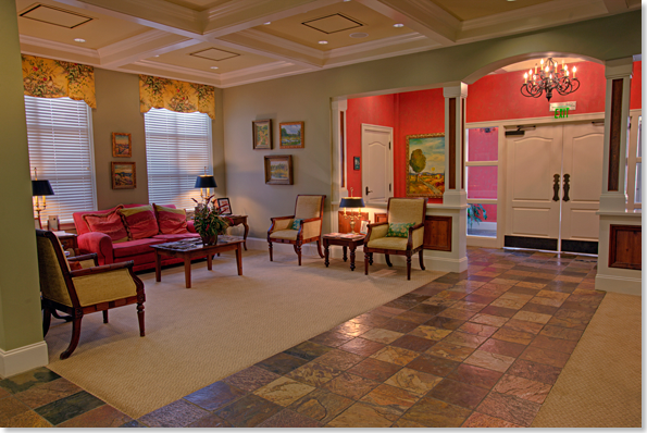 Spacious waiting area full of chairs and a red couch