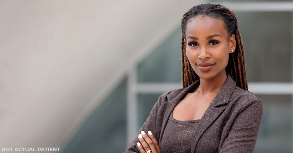 Woman standing and smiling confidently