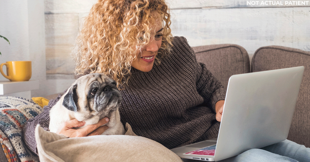 Woman sitting on a couch doing research online