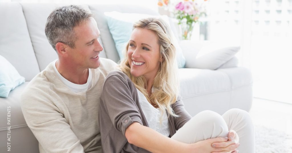 Man and woman with clear youthful skin cuddling (NOT ACTUAL PATIENTS)