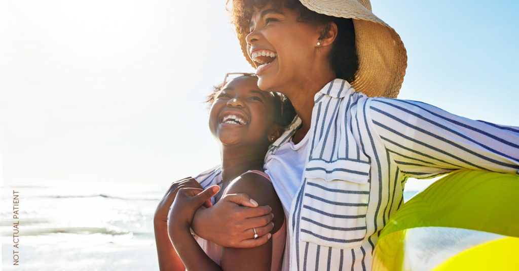 Mother and daughter enjoying the beach