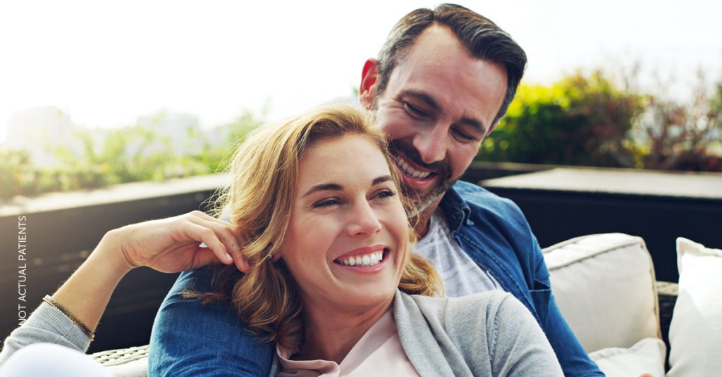 Man and woman smiling together (not actual patients)