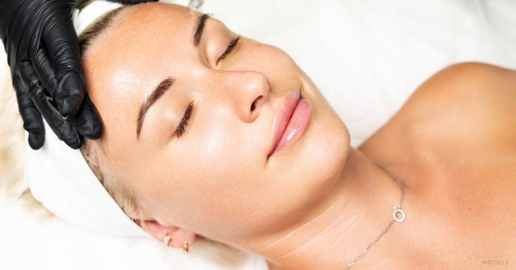 Woman receiver a laser treatment. (Models)